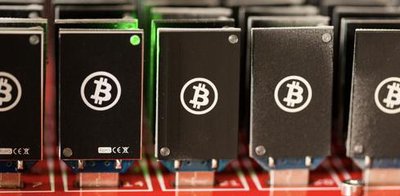 Rows of mining rigs in a data center environment highlight the scale and infrastructure of a mining farm.